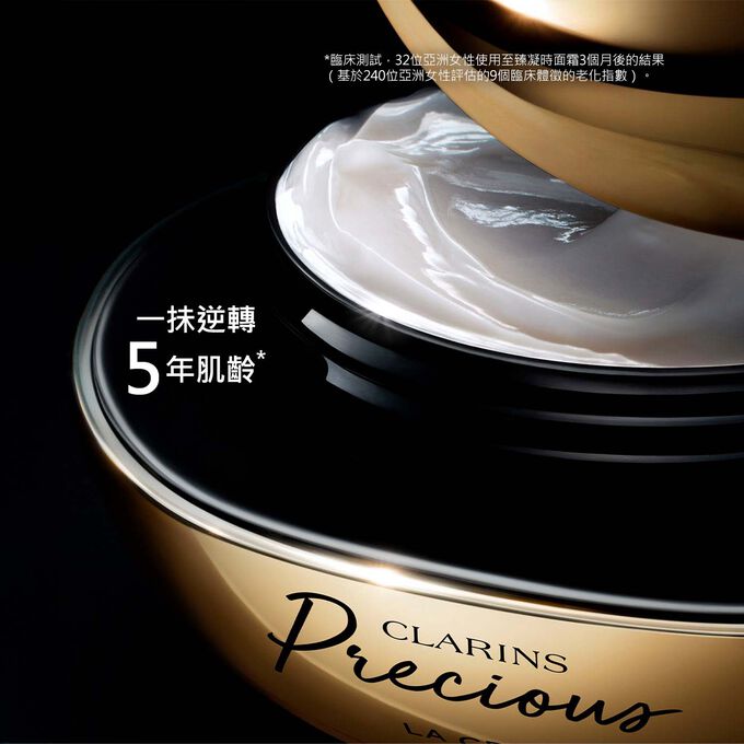 深色背景中的Clarins Precious至臻凝時面霜的宣傳照，並有一段文字強調產品可逆轉肌齡達5年